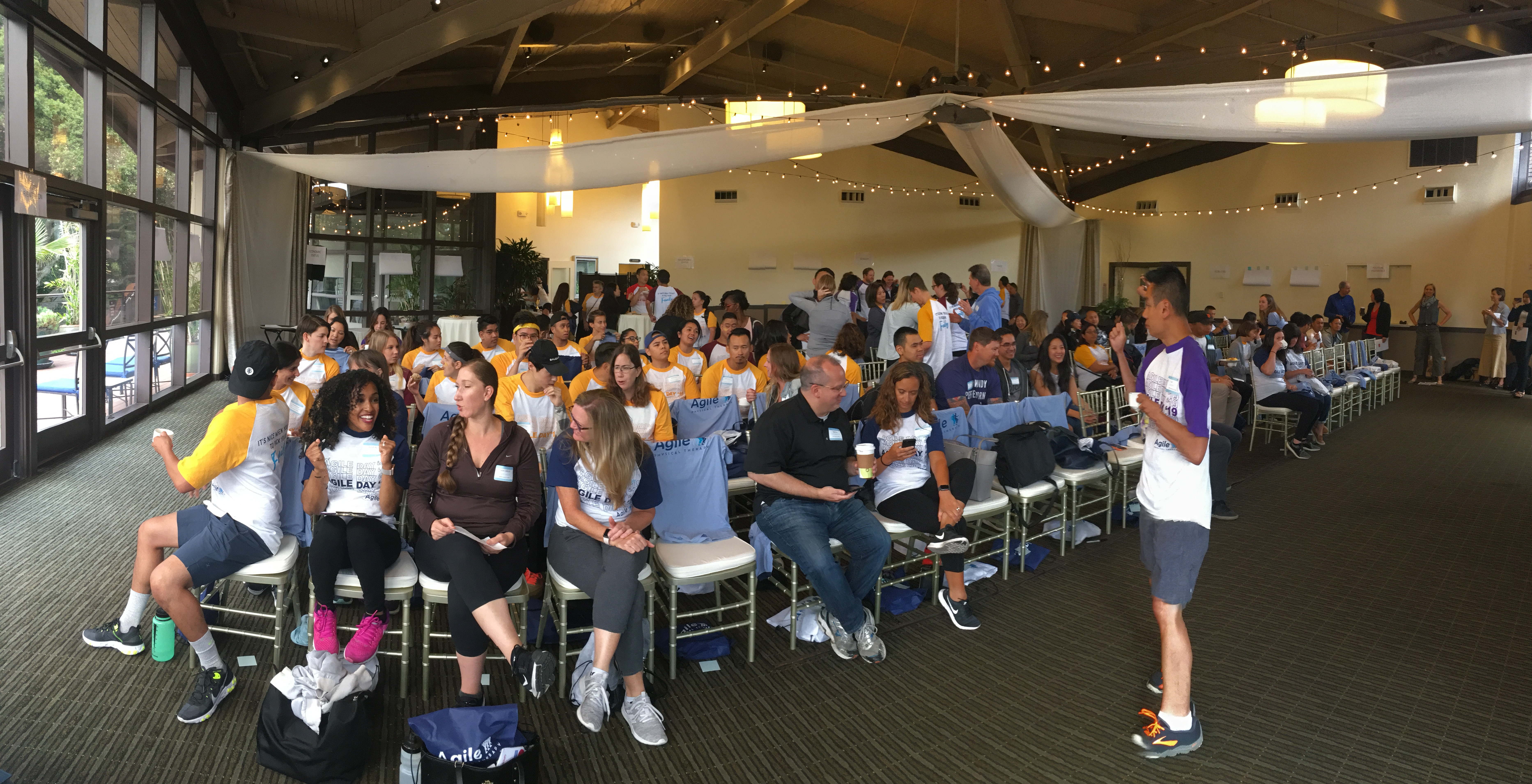 Employees gather at Agile Physical Therapy's "Agile State of the Company" event. Select employees were recognized with custom-branded Apple AirPods for their dedication to the company. Photo credit: Agility Physical Therapy