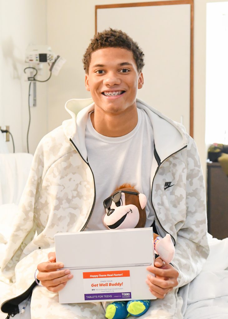 Toys for Hospitalized Children gifts Apple iPad with customized content to a teen patient at Hurley Medical Center in Flint, Mich. 